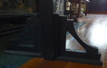 shelf brackets holding up stained glass window