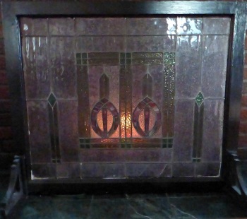 stained glass fireplace screen in front of fire