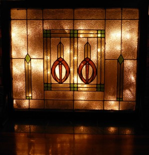 stained glass fireplace screen with Christmas lights behind