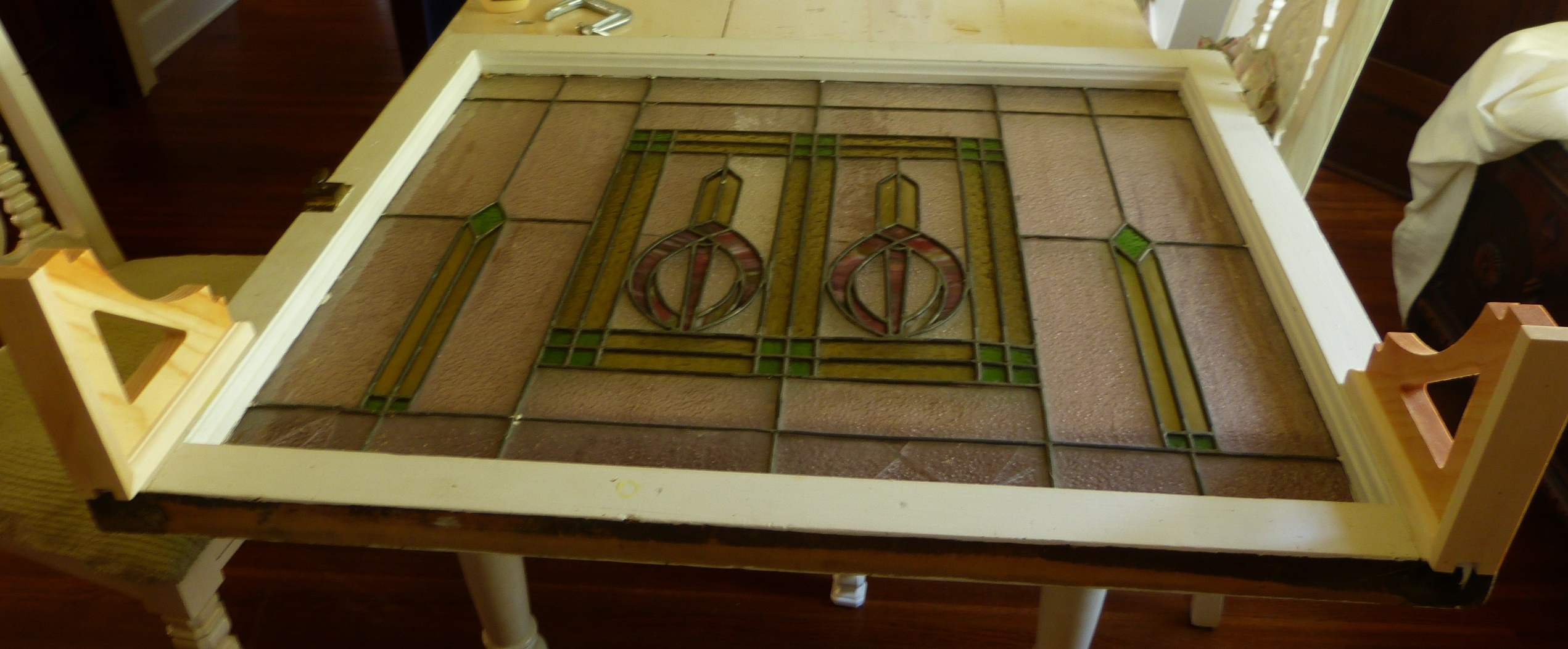 unpainted stained glass window with brackets